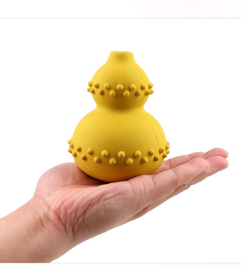 Yellow natural rubber interactive pet toy held in hand with textured surface for dogs
